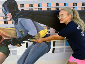 Batman & Robin mural with girl posing