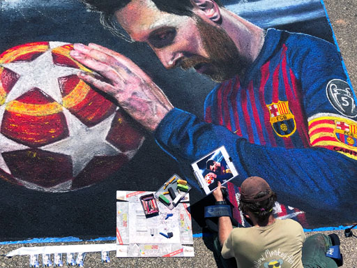 Working on Lionel Messi pavement chalk art