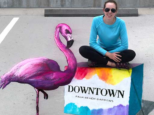 Posing with 3D flamingo pavement chalk art for Downtown Palm Beach Gardens