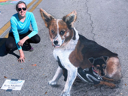 Posing with 3D dogs chalk art