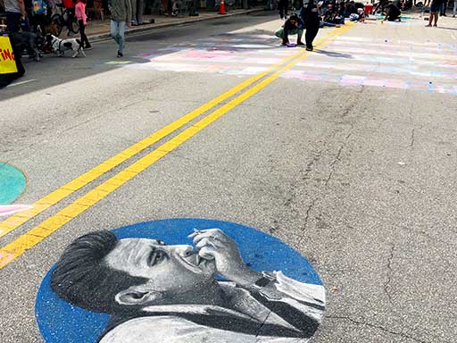 Wide angle of Johnny Cash portrait pavement chalk art