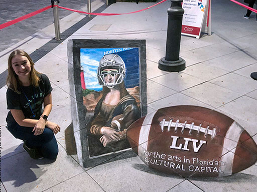 Posing with 3D Mona Lisa in a football helmet chalk art