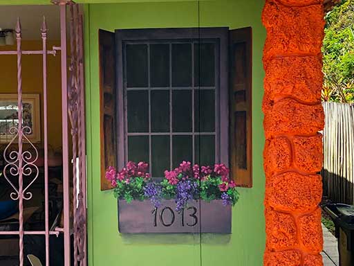 Faux window with flower box wall mural