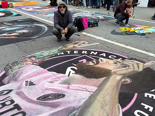 Posing with chalk image of Inter Miami soccer player Lionel Messi