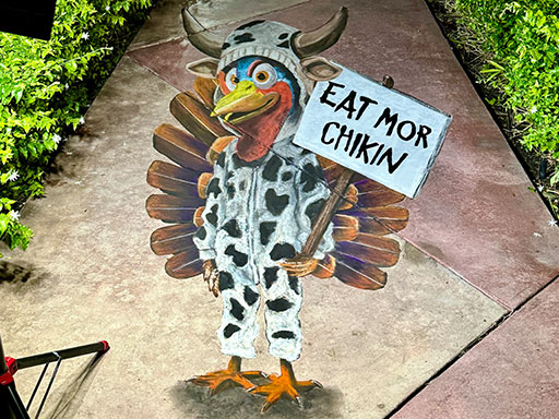 3D chalk art of a Thanksgiving turkey dressed as the Eat Mor Chikin cow.