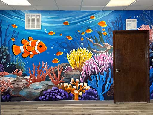 Angle view of wall mural featuring underwater coral and clownfish