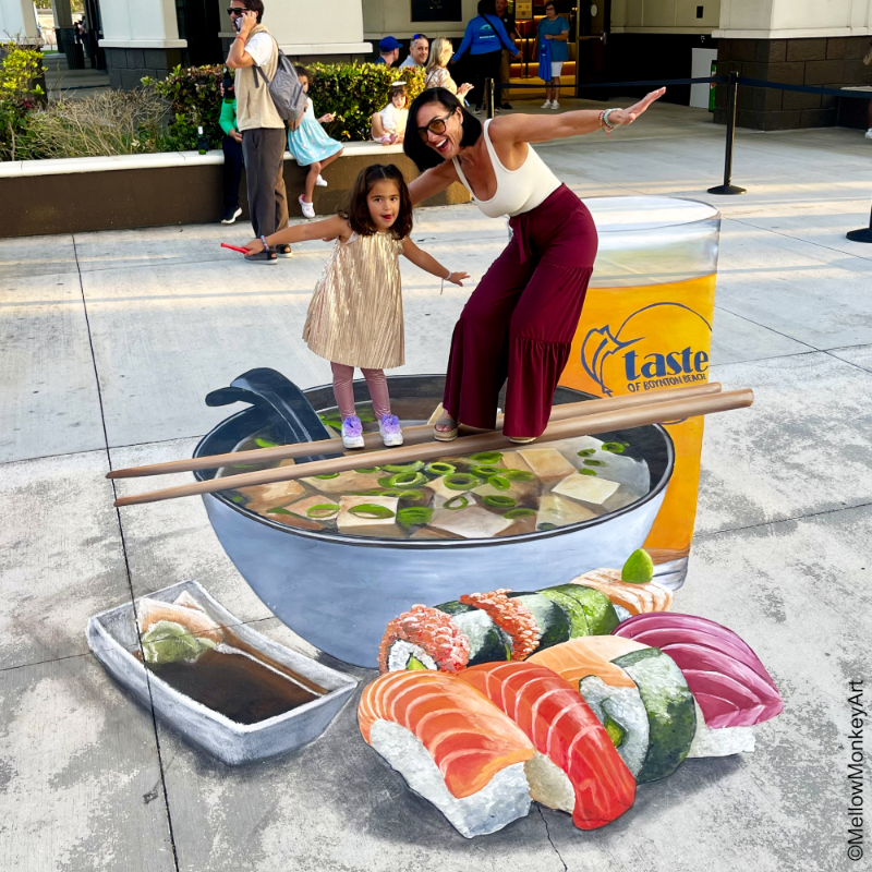 Posing with 3D chalk art of sushi with chopsticks, beer, and miso soup.